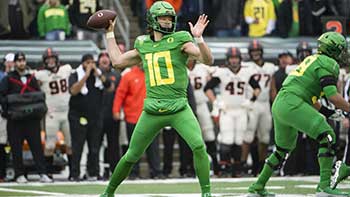 Justin Herbert throwing a football during a game