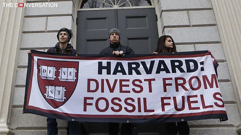 Harvard protesters holding banner