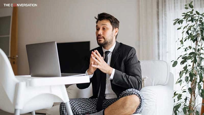 Man interviewing online wearing pajama bottoms