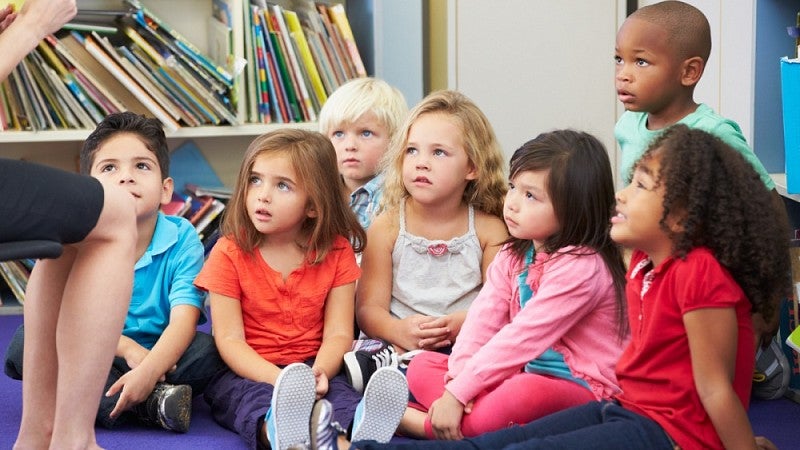 Presschool children listen to their teacher