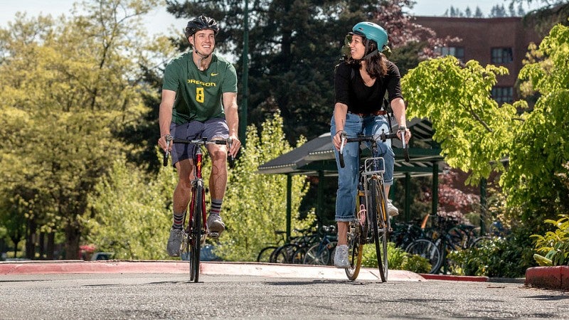 Bike-riding couple on UO campus