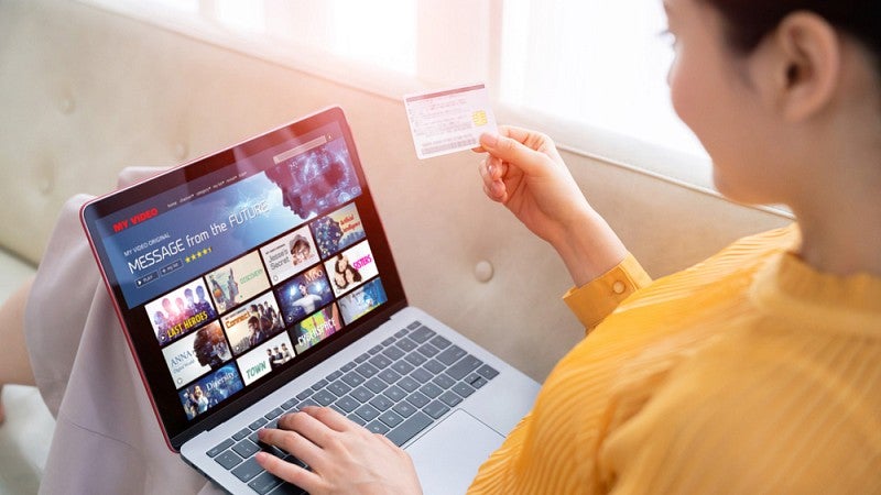 Woman selecting video on laptop