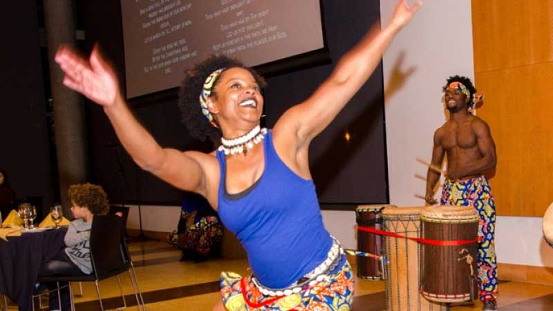 Ethnic studies professor Charise Cheney dancing while a drummer plays in the background