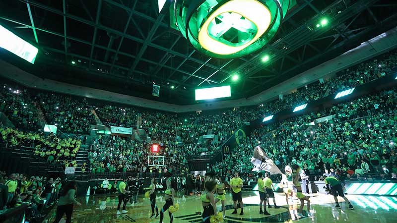 UO cheerleaders on the court durig pre-game introductions at Matthew Knight Arena with filled stands