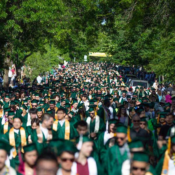 An overhead view of students walking down 13th Street during the Grad Parade