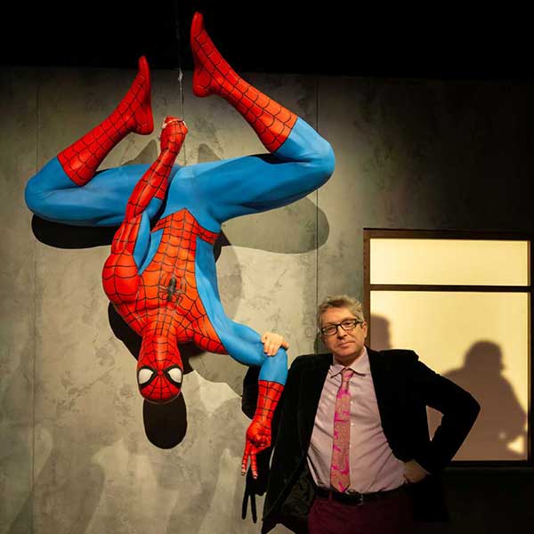 Ben Saunders standing next to Spiderman hanging upside down