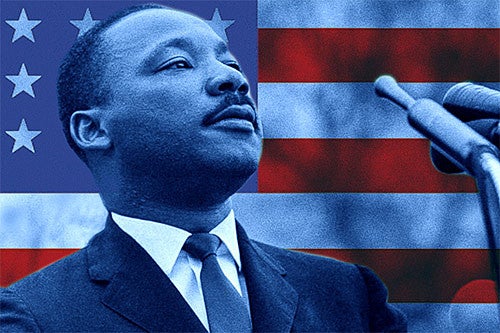 Martin Luther King Jr. with an American flag behind him