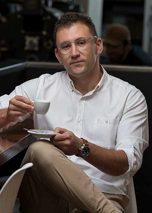 Christopher Hendon holding a coffee cup