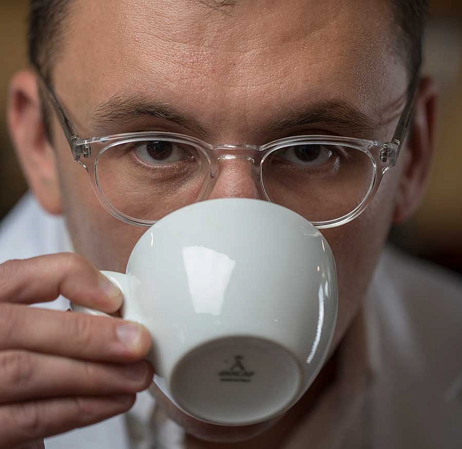 Christopher Hendon sipping from a coffee cup