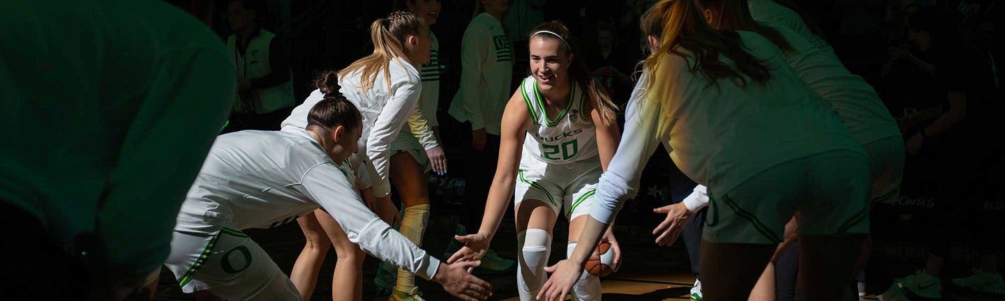 Sabrina Ionescu slapping her teammates hands as she is introducted before the game