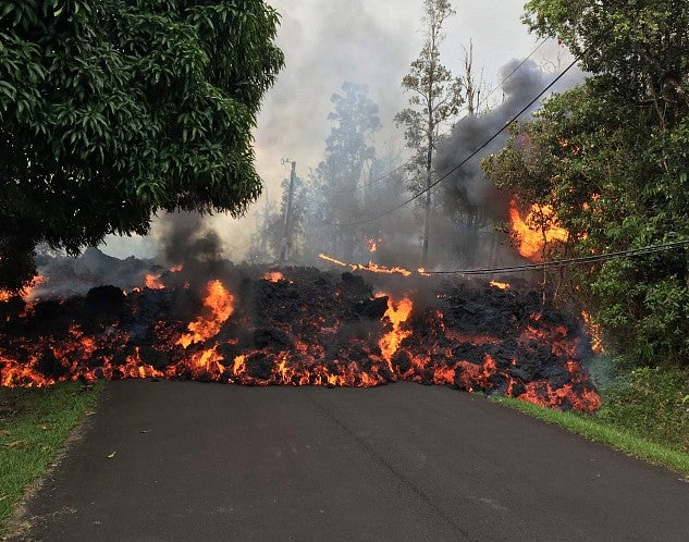 A wall of lava advances down a road