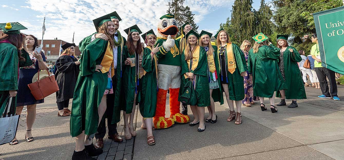 Graduates take a photo with the Duck before the 2018 grad parade