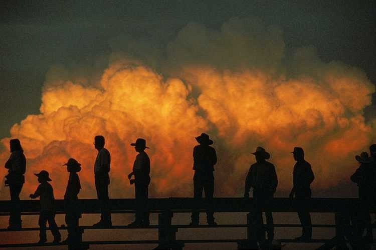 Silhouetted fans watch the Big Rodeo at Burwell in central Nebraska. Photograph by Joe Sartore - National Geographic Stock 