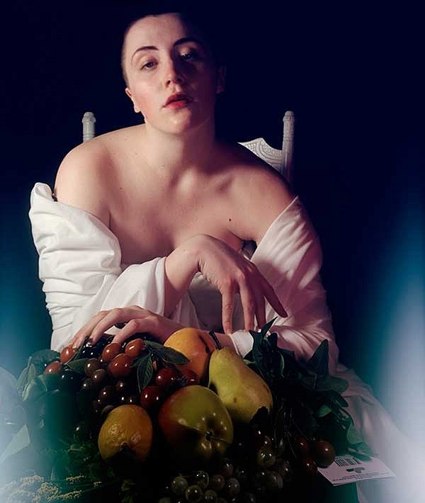 Photo of a person with a bowl of fruit in front of them