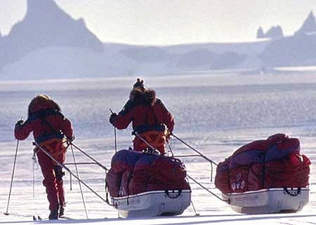 Ann Bancroft and Liv Arnesen pulling sleds on the Antarctic Crossing 2000