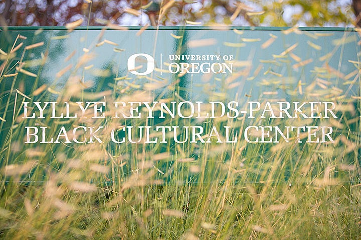 Lyllye Reynolds-Parker Black Cultural Center sign as viewed through plants