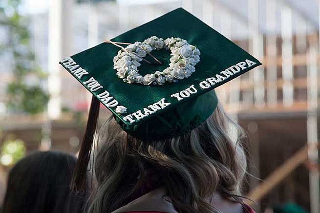 Graduation cap reads: Thank you dad. Thank you grandpa.
