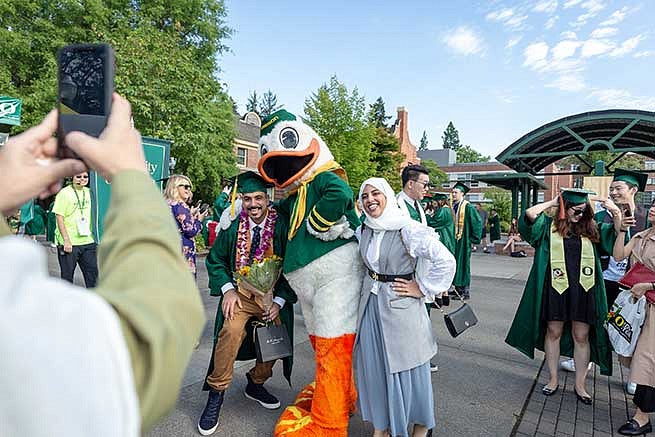 Students are always excited to pose with the Duck, especially on graduation day