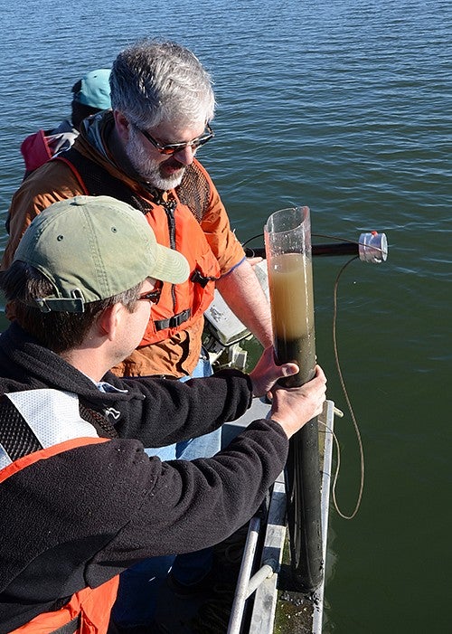 Study co-authors Dan Gavin and Josh Roering check a core of sediment taken from the South Slough