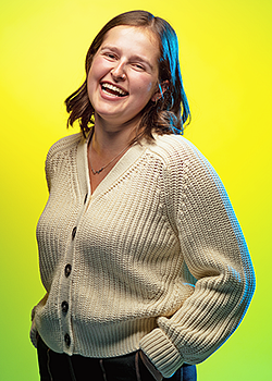 Eliza Lawrence pictured in front of a vivid yellow background