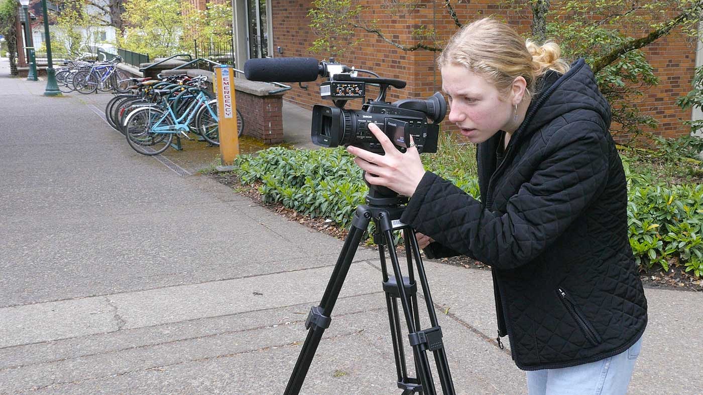 Emily Robinson working with a video camera