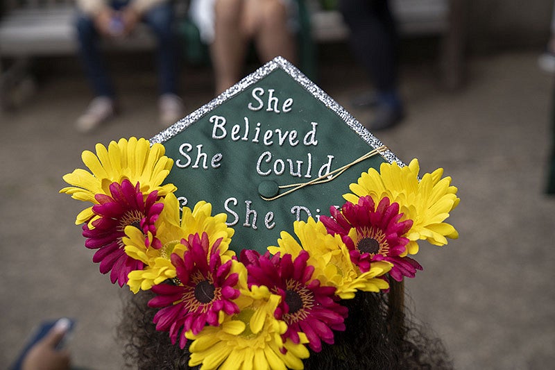 A graduation cap reading "She believed she could so she did"