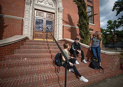 Students sitting on the steps outside of Chapman Hall