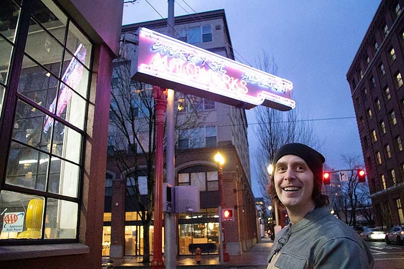 Jeremy Ebersole outside near a neon sign