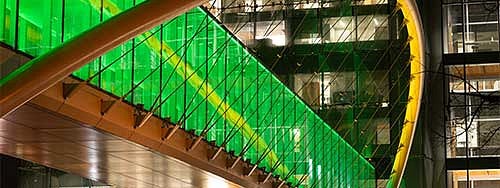The Knight Campus skybridge lit up in green and yellow