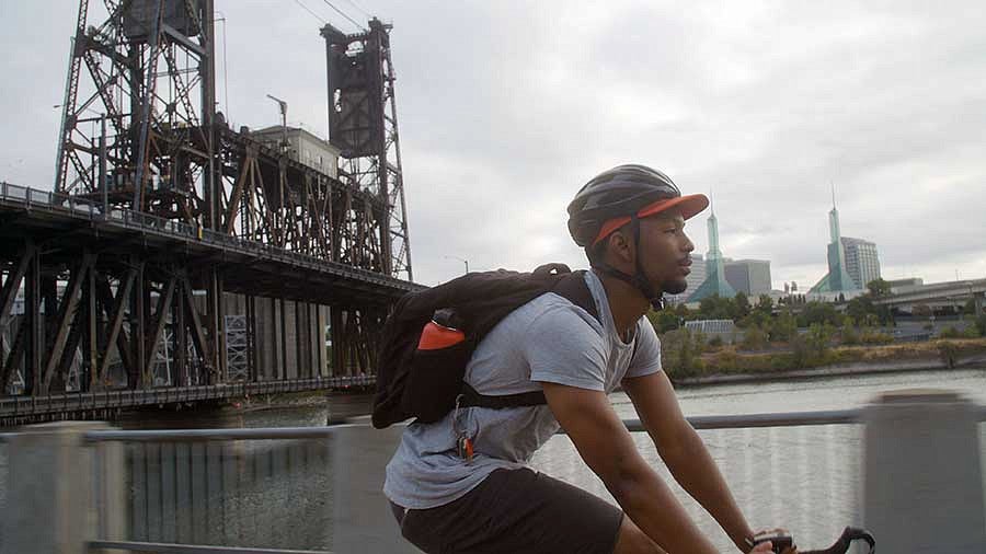Kodi Whitfield biking near the Willamette River in Portland