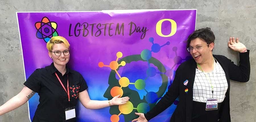 Tzula Propp and another student in front of the LGBTSTEM Day poster