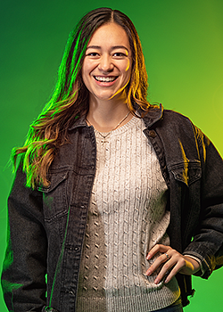 Natasha Reyes pictured in front of a vivid green background