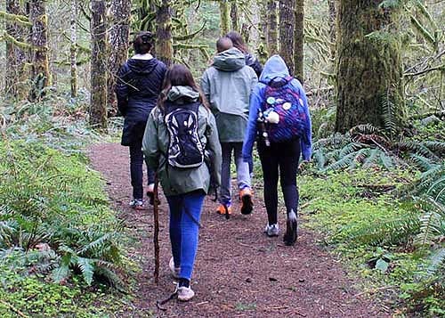 Students from Creston Elementary School walking through the woods