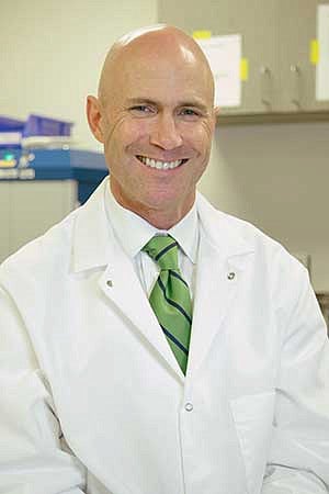 Robert Guldberg in a white lab coat in a lab