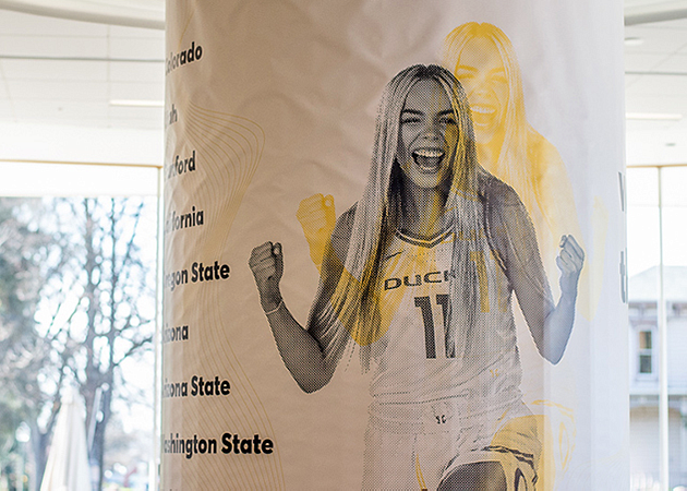 A banner advertising Oregon Women's Basketball is shown wrapped around a column in the student center