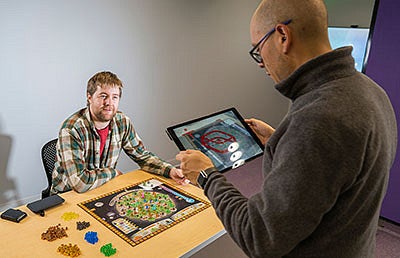 Robin FitzClemen and Maxwell Foxman take Robin’s board game, Wildfire, for a test run.
