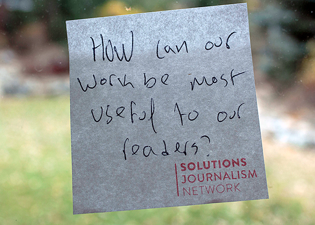 a sticky note on a window reads "how can our work be most useful to our readers?"