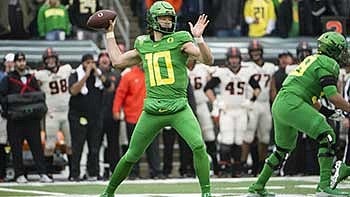Justin Herbert throwing a football during  a game
