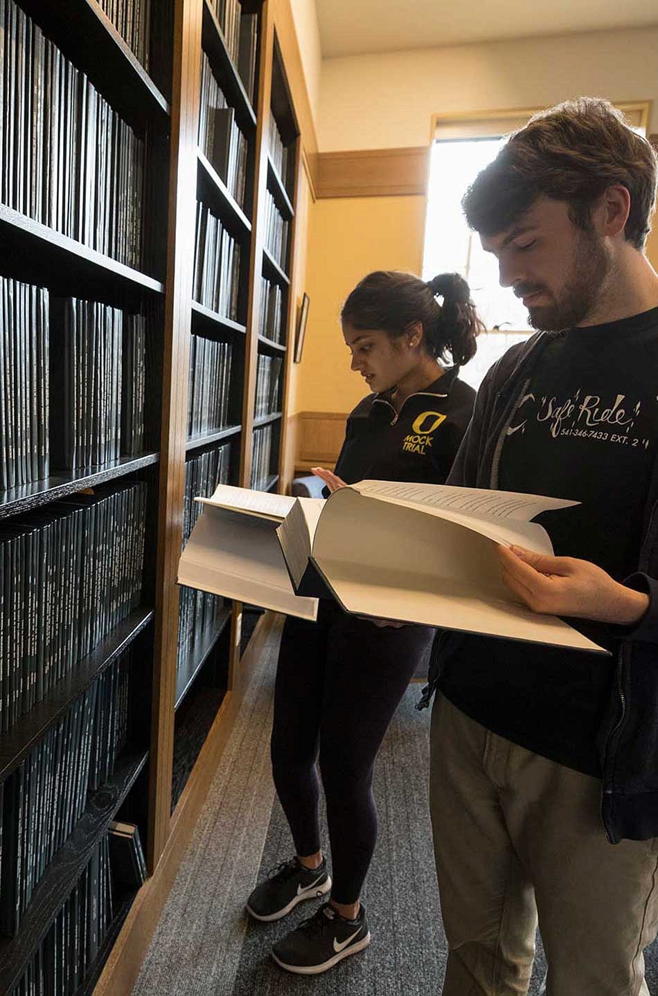 Two students looking to the thesis archive in Chapman Hall