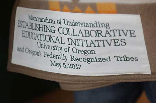 Patch on a blanket that says Memorandum of Understanding establishing collaborative educational initiatives – University of Oregon and Oregon’s federally recognized Tribes – May 5, 2017