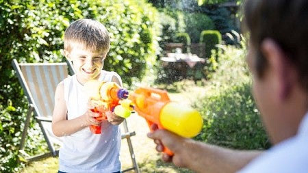 Child playing with squirt gun