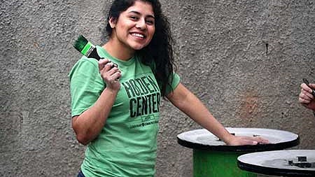 UO student painting stoves during Alt Break in Guatamala