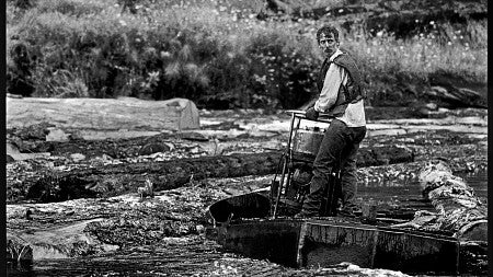 A logger navigating a "log pond."