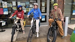 Members of the UO community on different e-bike models 