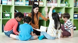 Teacher working with young students