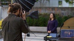 University photographer takes a staff portrait outdoors