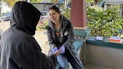 Researcher talking with homeless man