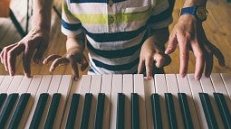 Boy learning piano