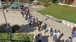 students in line for produce drop at EMU amphitheater