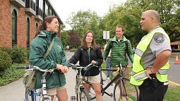UO PD Community Officer talking with students on bikes